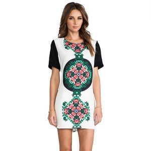 Fun mini dress with unique floral detail.